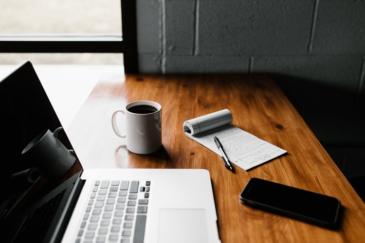 content marketing on laptop with notepad pen coffee and smartphone